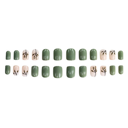 Tea-colored green leaves with painted nails