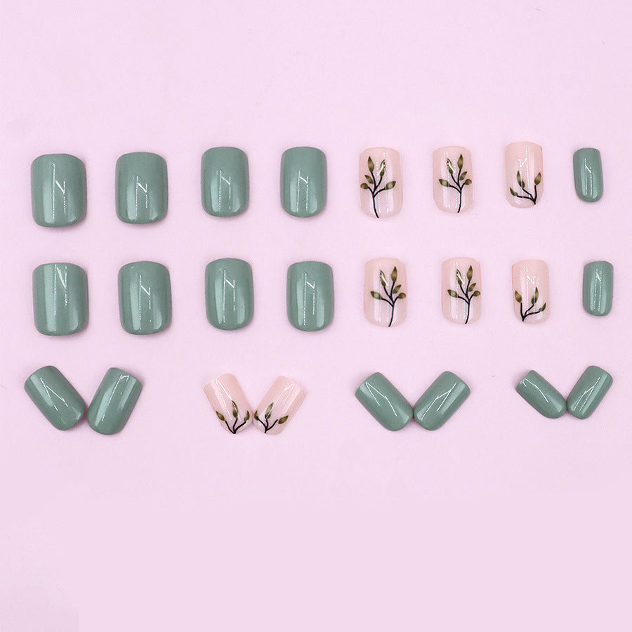 Tea-colored green leaves with painted nails