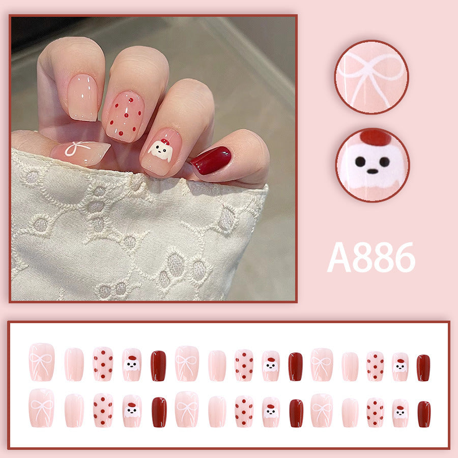 Red polka-dot hat, cute puppy, beautiful nails