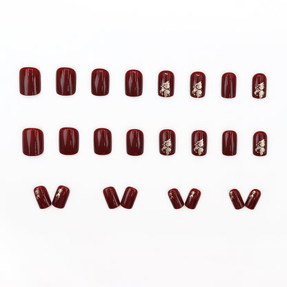 Anclara's red manicured nails