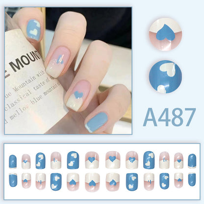 Dark blue and white heart-shaped nail polish