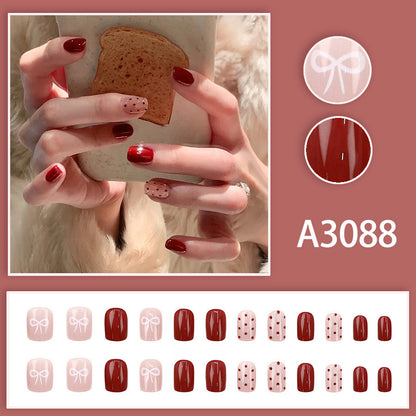 Red polka dot nude pink bow-shaped nail art