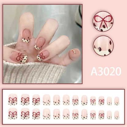 Bare color powder bow leopard print nail art