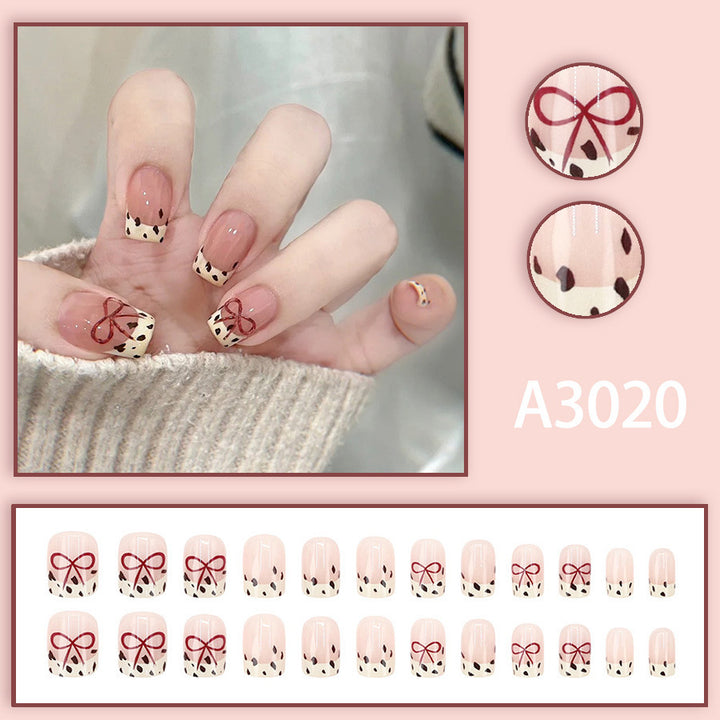 Bare color powder bow leopard print nail art
