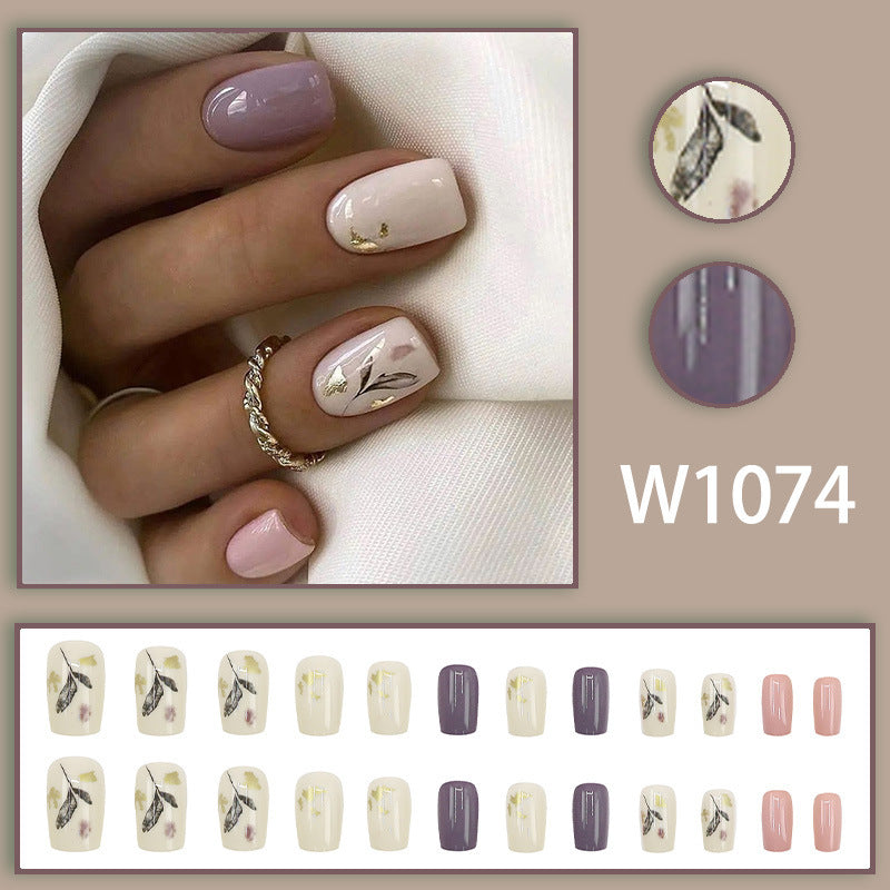 Leaves adorning gold foil manicure
