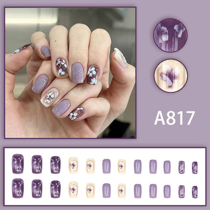 Simple square-shaped nail polish with purple flowers and a beautiful design