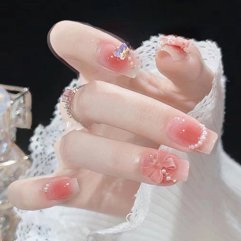 Red bow-shaped pearl manicure